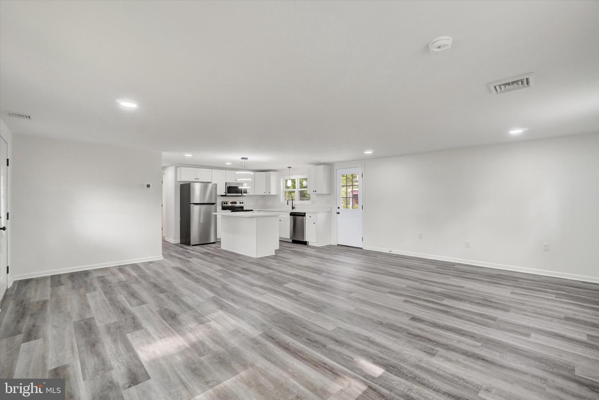 761 2nd Avenue Manchester, PA 17345 - Photo 11 of 29 a view of a electric appliances in kitchen and empty room with wooden floor