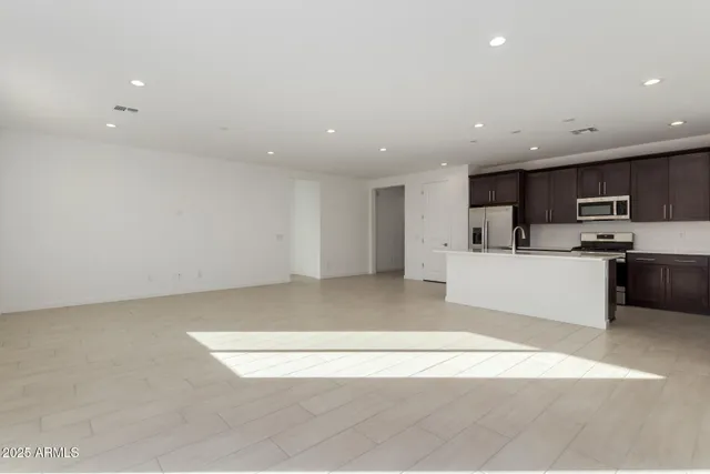 a view of kitchen with microwave oven a sink and cabinets