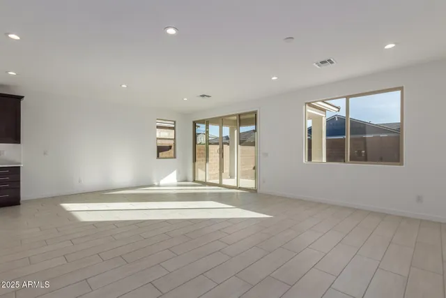 a kitchen with stainless steel appliances a stove top oven a sink a refrigerator and a window