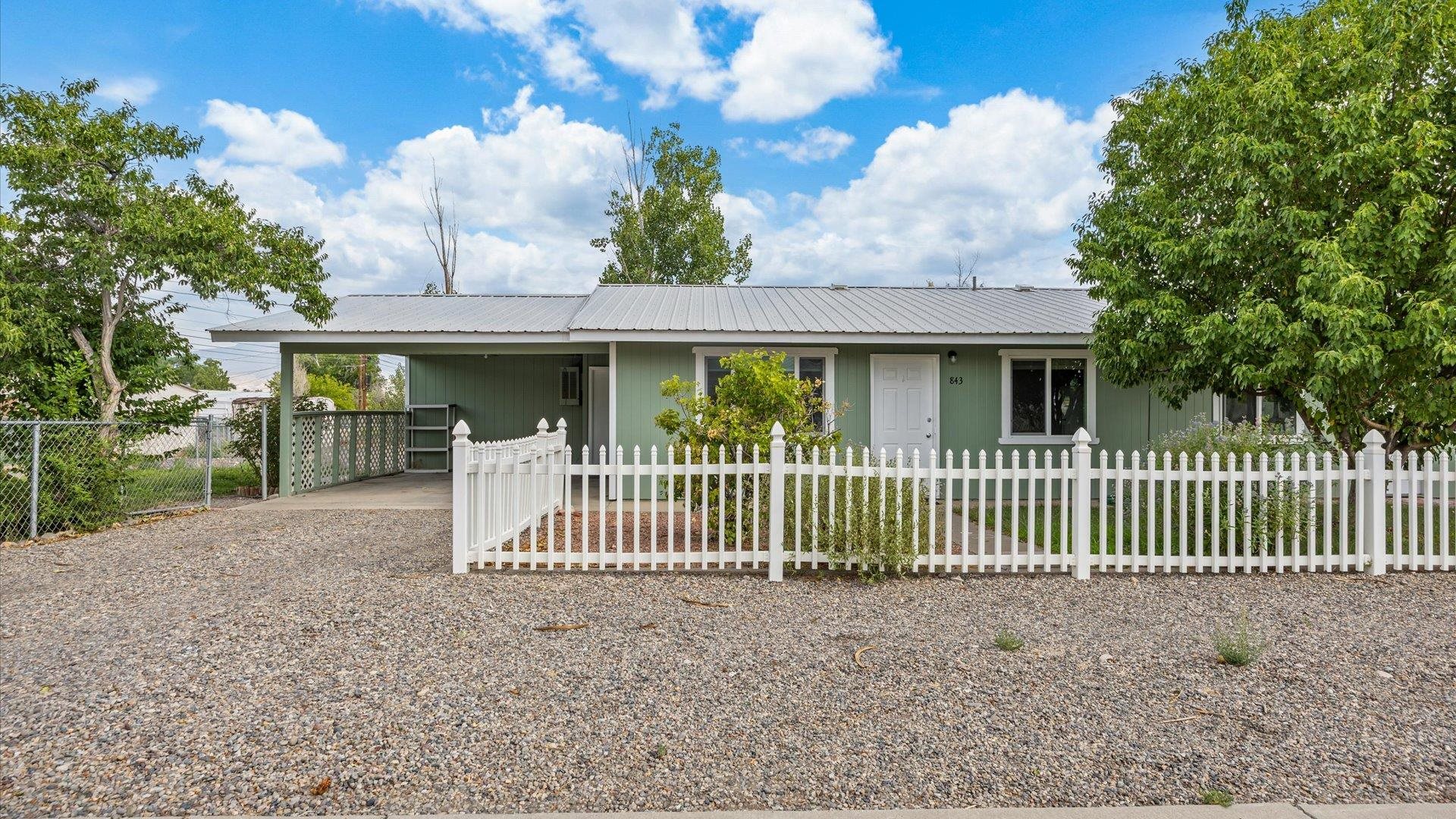 a view of a house with a small yard and plants