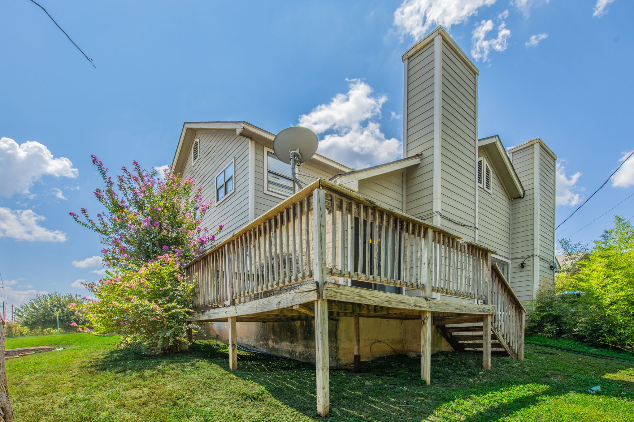 2000 Kenneth Avenue, Unit B Austin, TX 78741 - Photo 22 of 22 A spacious wooden deck extends from the rear of the home, offering ample space for outdoor enjoyment.
