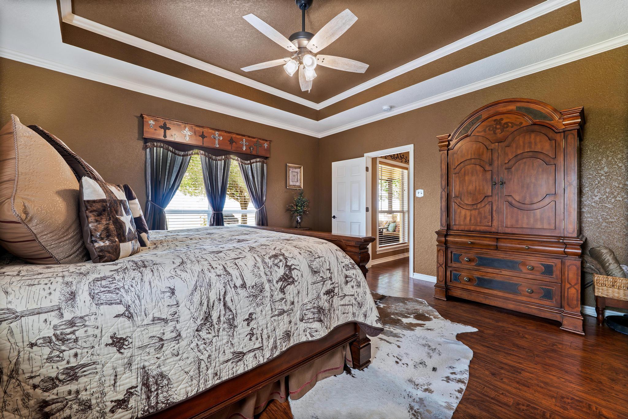 19000 Farm To Market Road 971 Granger, TX 76530 - Photo 18 of 40 The bedroom features a tray ceiling and wonderful natural light.