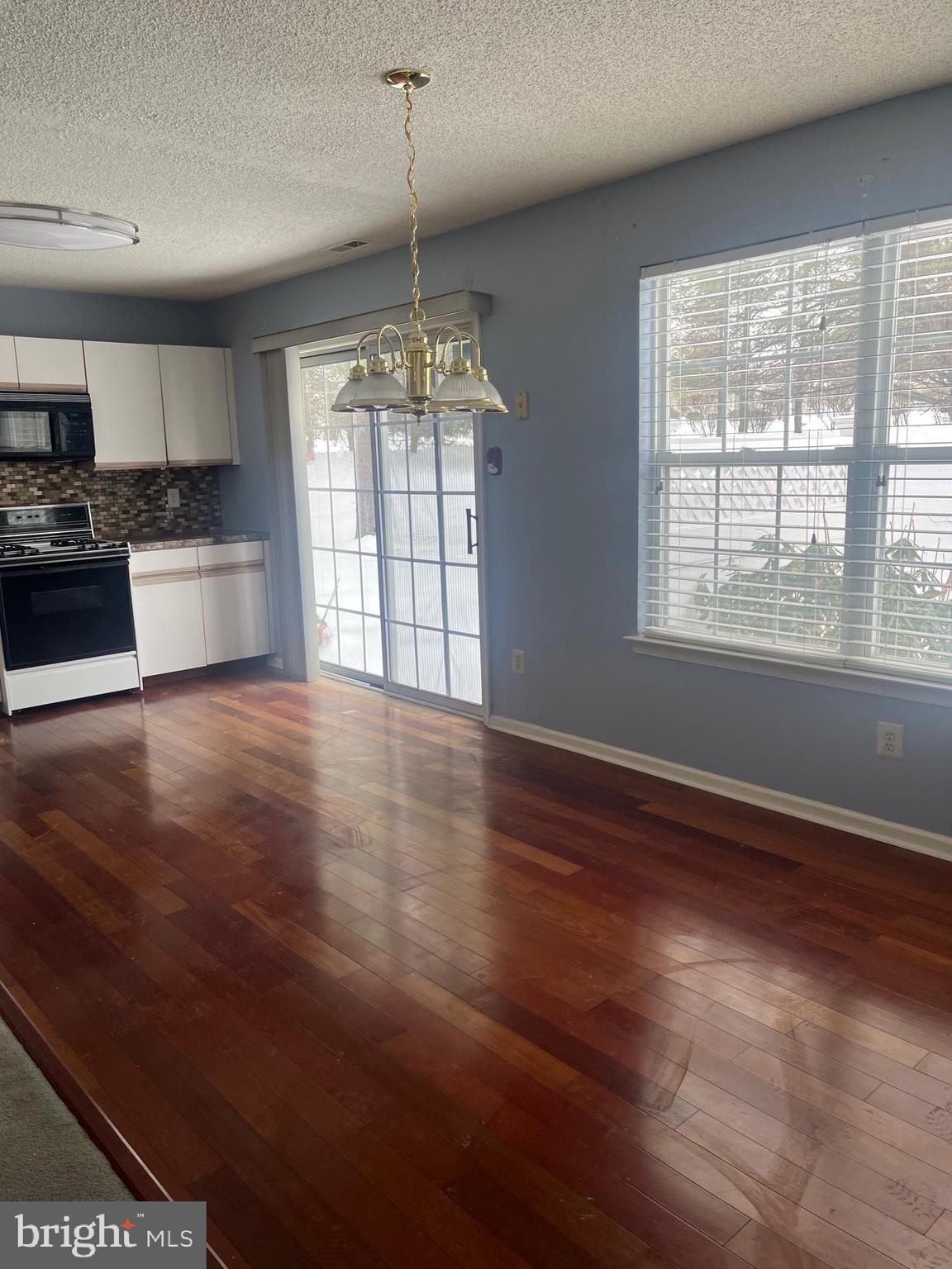1826 Mansfield Street Hellertown, PA 18055 - Photo 37 of 52 a view of an empty room with window and wooden floor