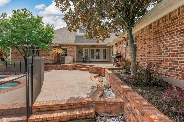 a view of a grassy field with trees in the background
