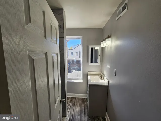 a bathroom with a sink and mirror