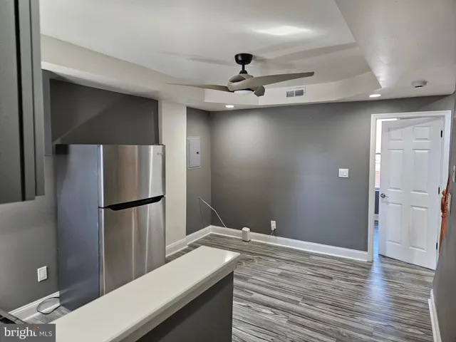a view of a kitchen with a sink and a refrigerator