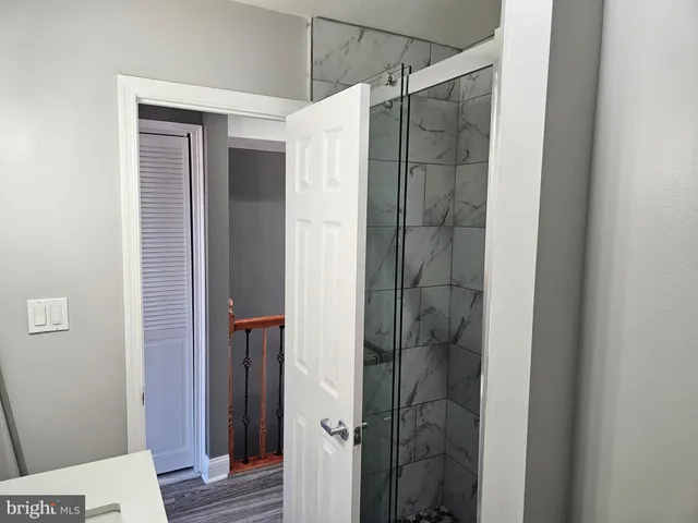 a bathroom with a shower and a sink