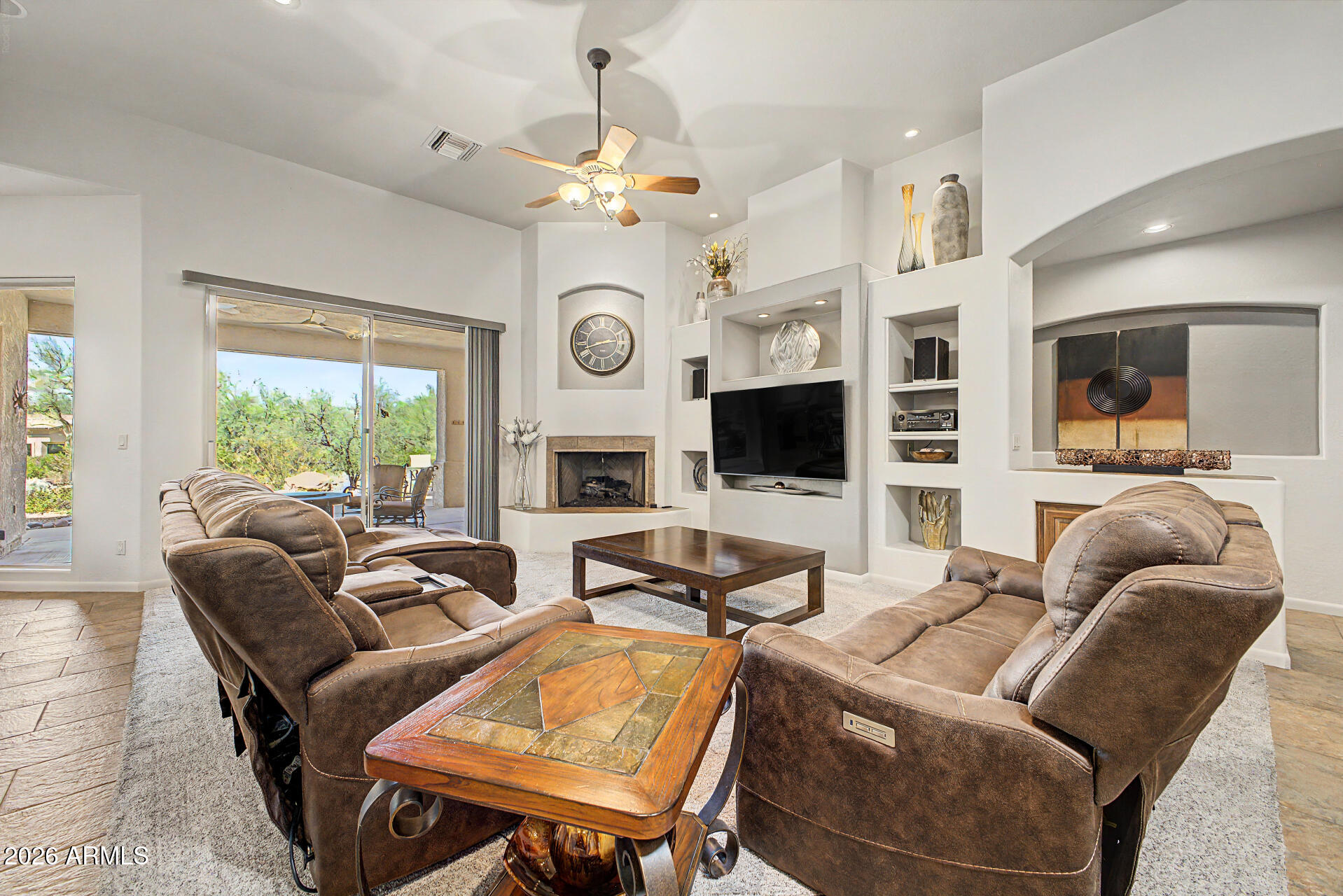 27909 North Quail Spring Road Rio Verde, AZ 85263 - Photo 7 of 52 a living room with furniture a fireplace and a large window