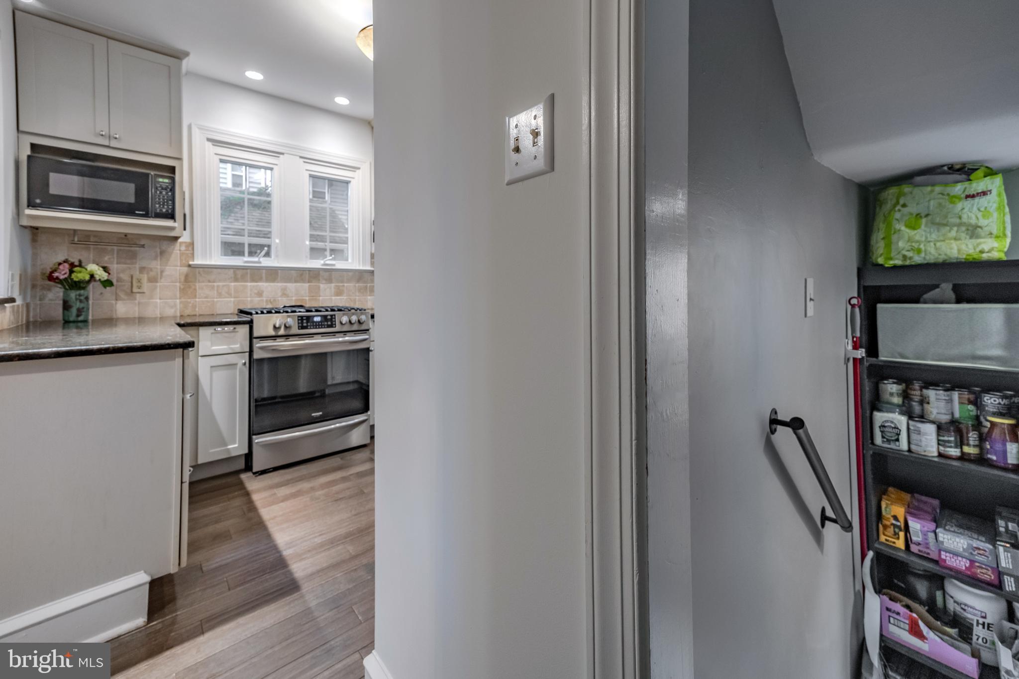 239 Cherry Lane Havertown, PA 19083 - Photo 20 of 49 a kitchen with stainless steel appliances granite countertop a stove top oven a sink and a refrigerator