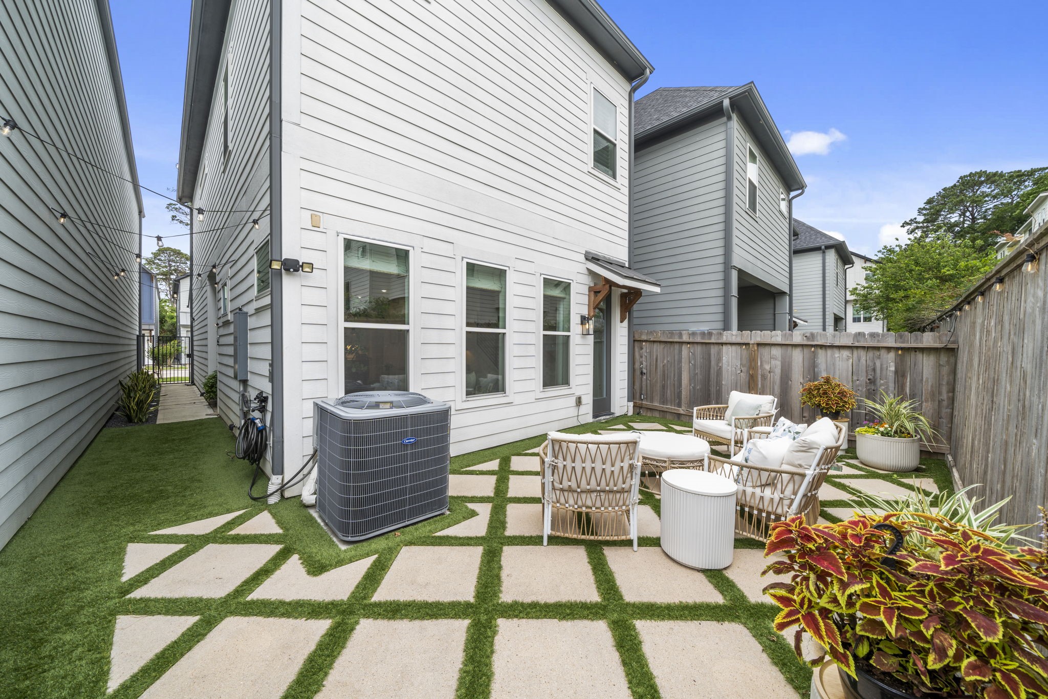 9018 Wellspring Drive Houston, TX 77080 - Photo 20 of 25 The rear view of this 2020-built home showcases the durable cement board siding and the fully fenced perimeter, ensuring maximum privacy for your modern outdoor sanctuary.