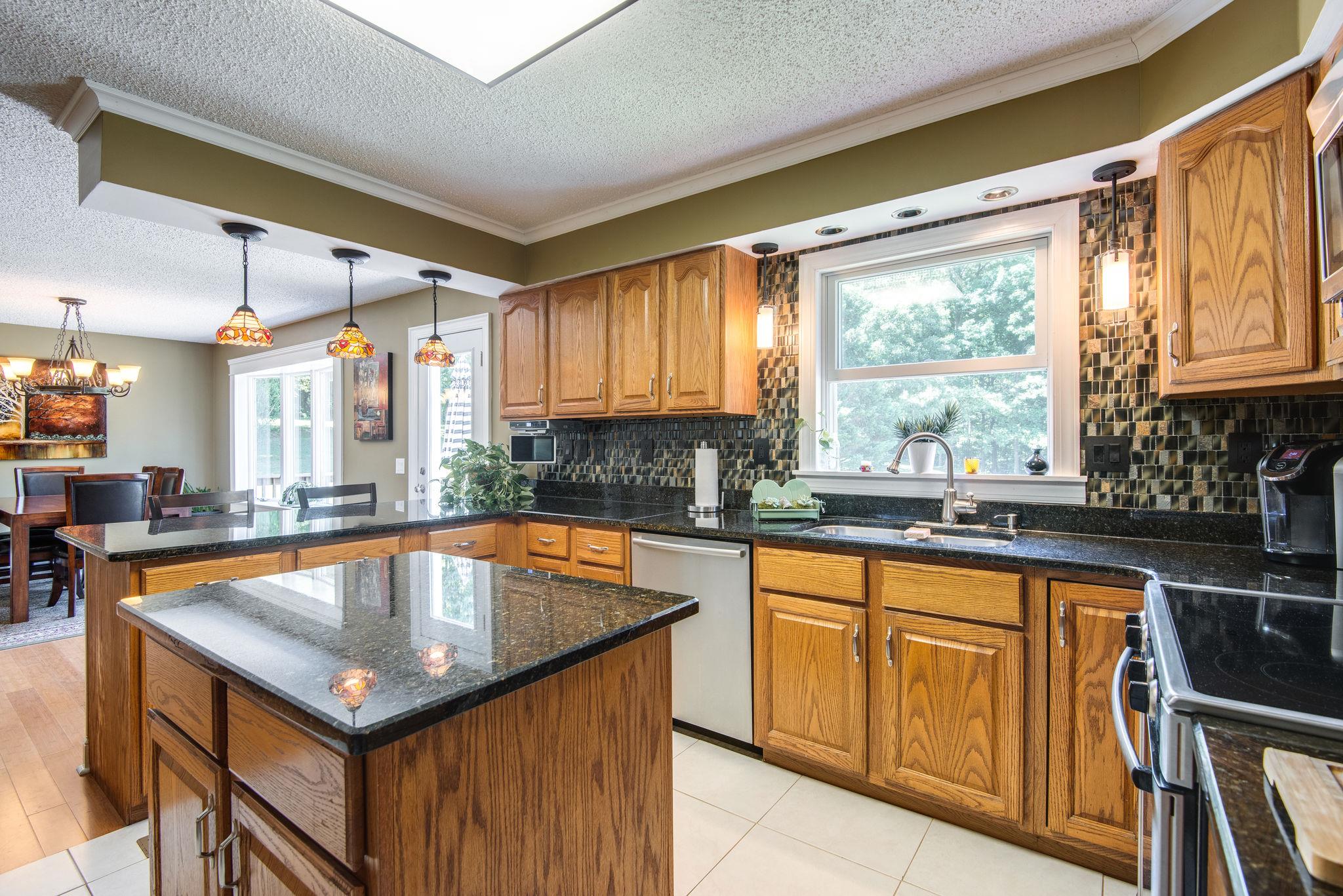 410 Baker Road Dickson, TN 37055 - Photo 16 of 30 a kitchen with a sink a counter top space cabinets and stainless steel appliances