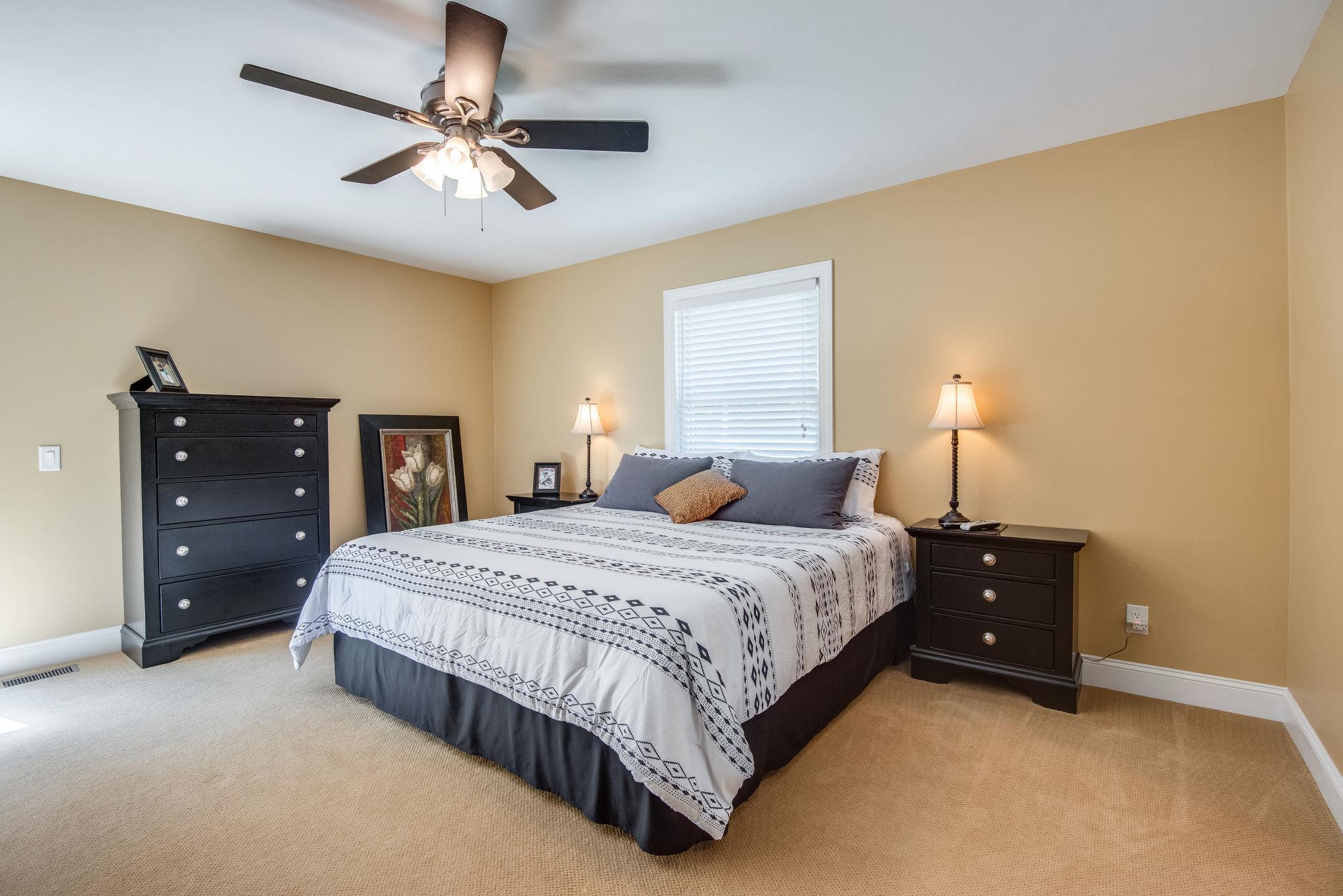 410 Baker Road Dickson, TN 37055 - Photo 17 of 30 a bedroom with a bed and a lamp