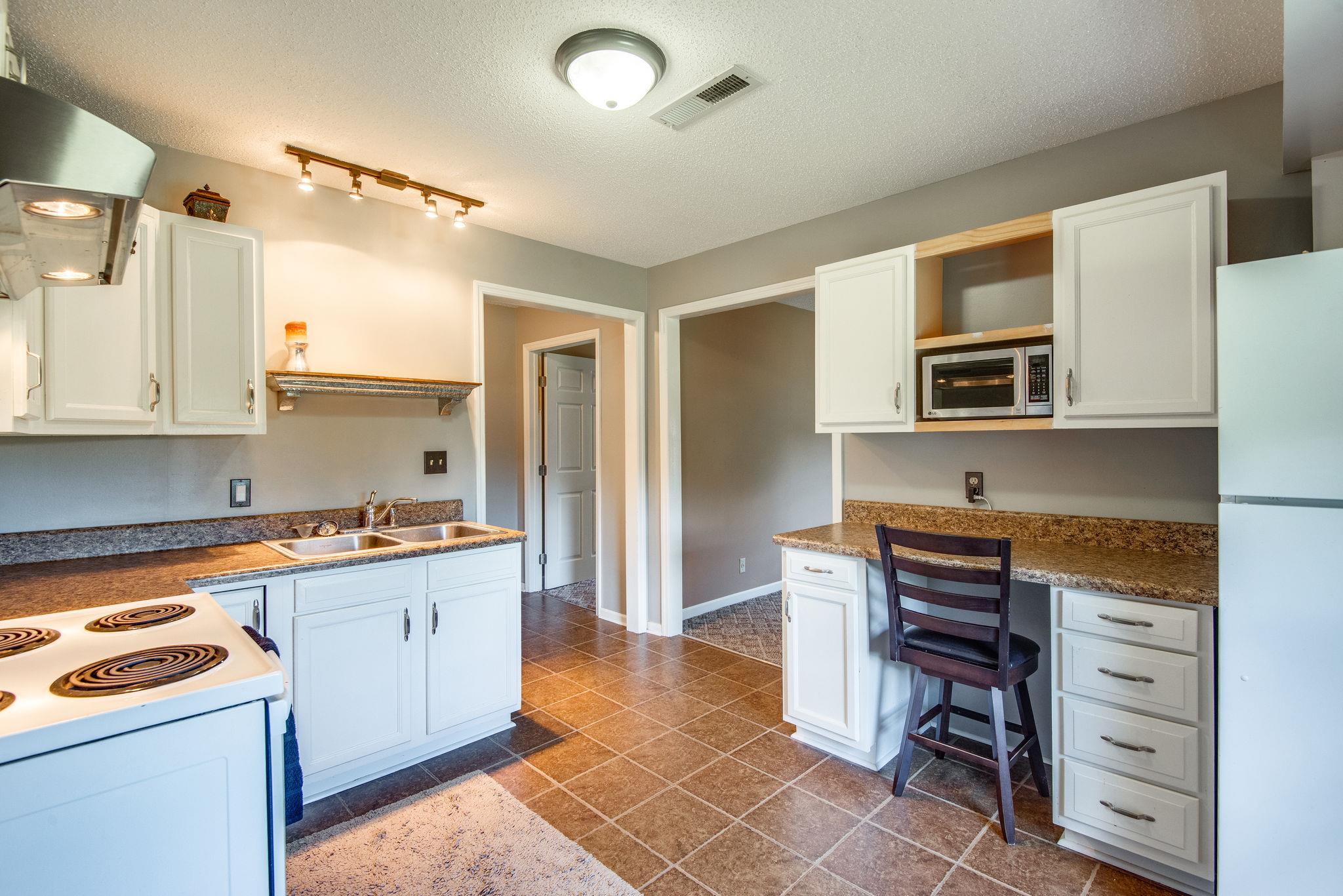 410 Baker Road Dickson, TN 37055 - Photo 28 of 30 a kitchen that has a stove and a refrigerator