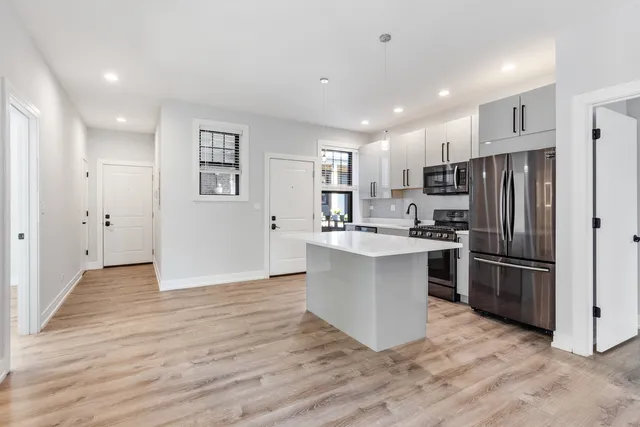 a kitchen with a refrigerator and a sink