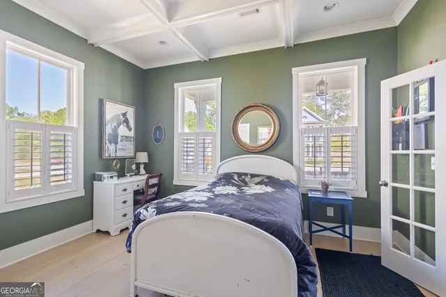 a bed sitting in a bedroom next to a window