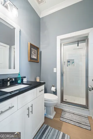 a kitchen with stainless steel appliances granite countertop a stove top oven a refrigerator a sink and white cabinets