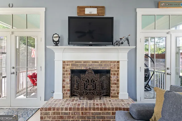 a kitchen with a stove a sink dishwasher a dining table and chairs with wooden floor