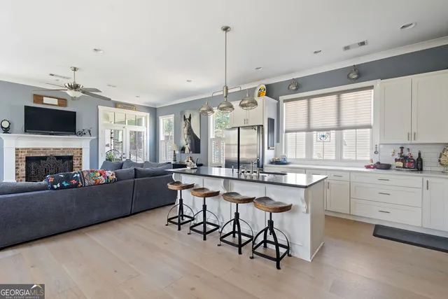 a view of a hallway with a livingroom and windows