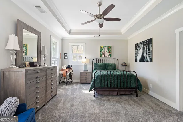 a kitchen with white cabinets and window