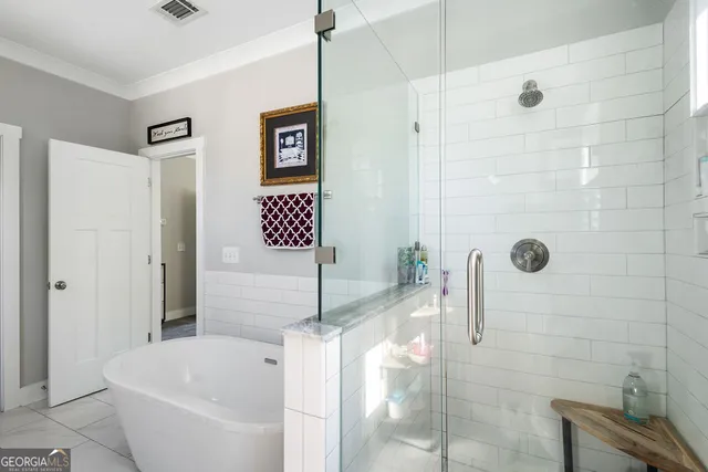 a bathroom with a bathtub and shower