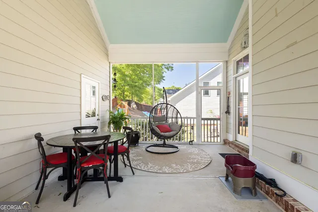 a living room with furniture and air hockey table