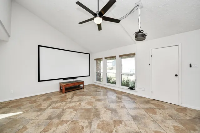 a view of room with window and ceiling fan