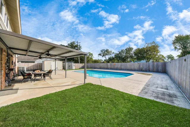 a view of yard with swimming pool and sitting area