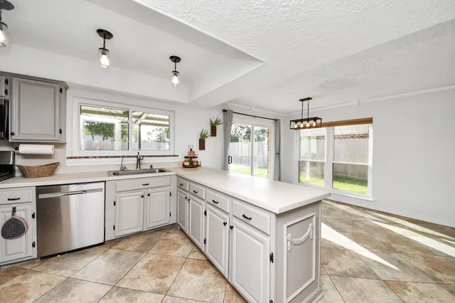 a spacious kitchen with cabinets and sink