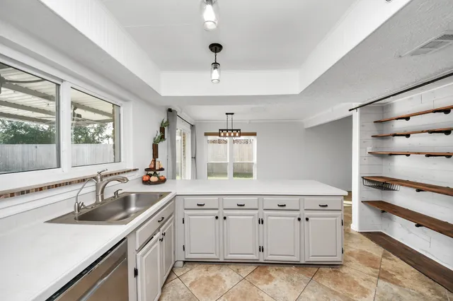 a kitchen with a sink stove and window