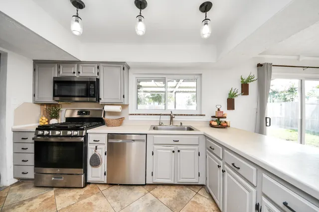 a kitchen with a stove sink and microwave