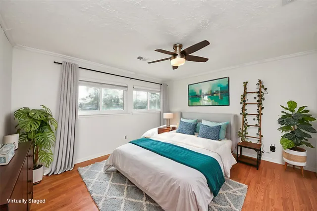 a bedroom with a balcony a bed and a potted plant
