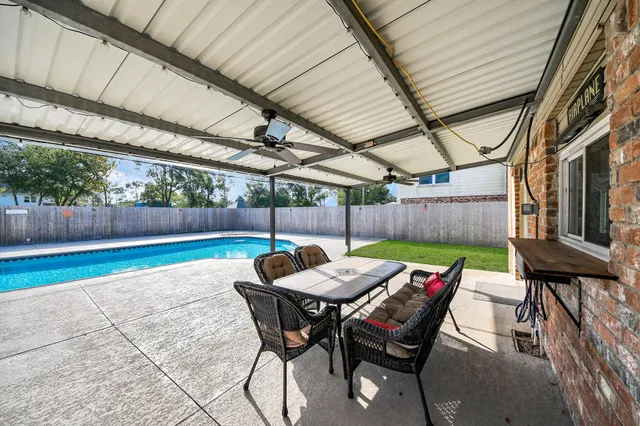 a backyard of a house with a table and chairs