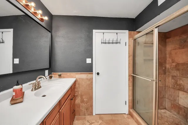 a bathroom with a tub sink and mirror