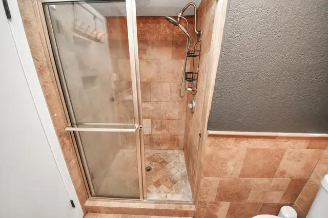 a bathroom with a glass shower door