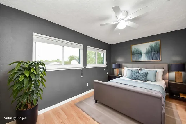 a bedroom with a large bed and a potted plant