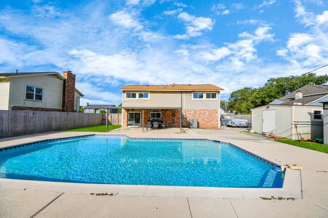 a view of swimming pool with outdoor seating