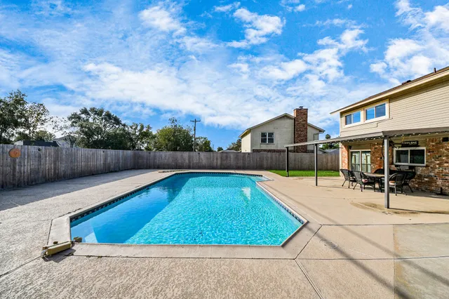 a swimming pool with wooden fence