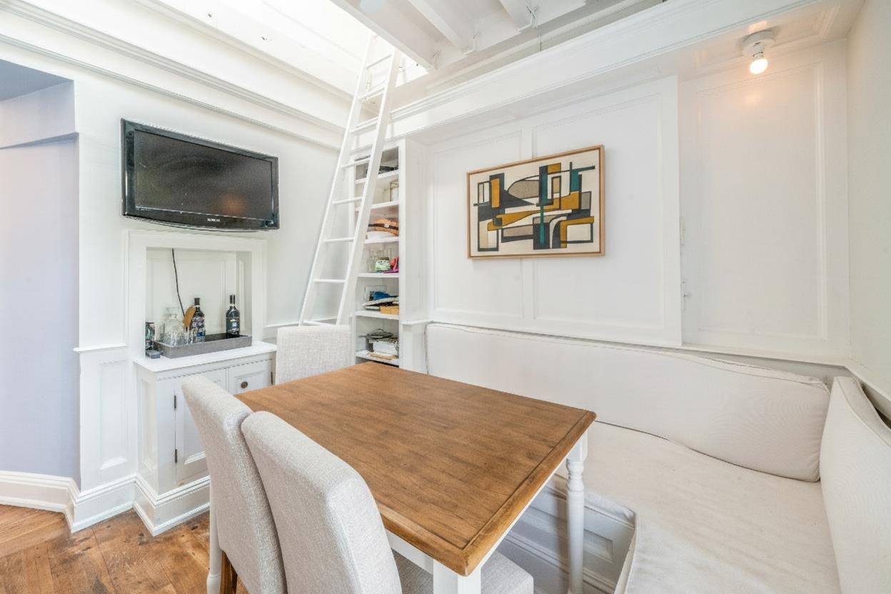 245 3rd Street, Unit 2 Jersey City, NJ 07302 - Photo 14 of 19 a bedroom with a bed and a flat screen tv