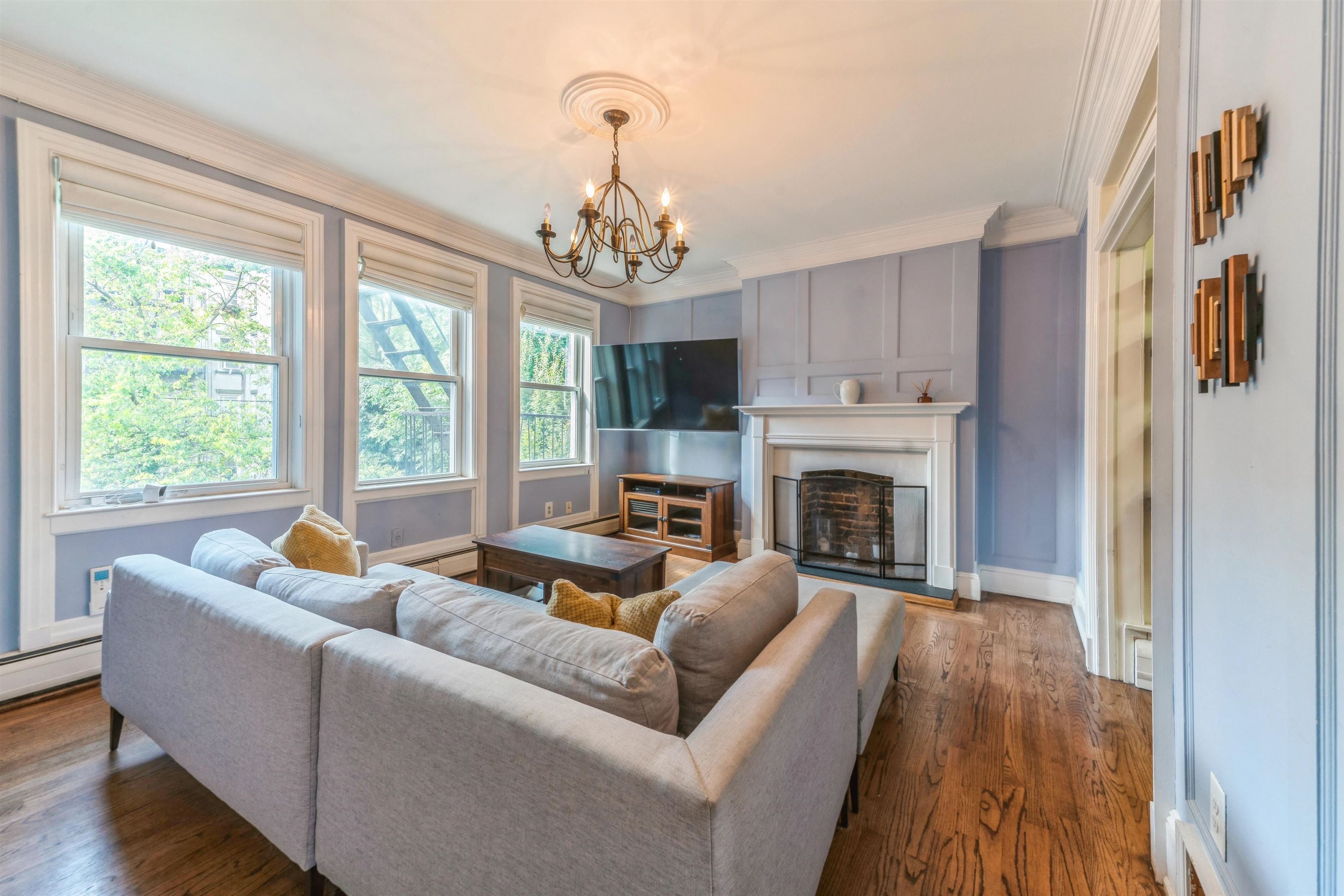 245 3rd Street, Unit 2 Jersey City, NJ 07302 - Photo 15 of 19 a living room with furniture fireplace and flat screen tv