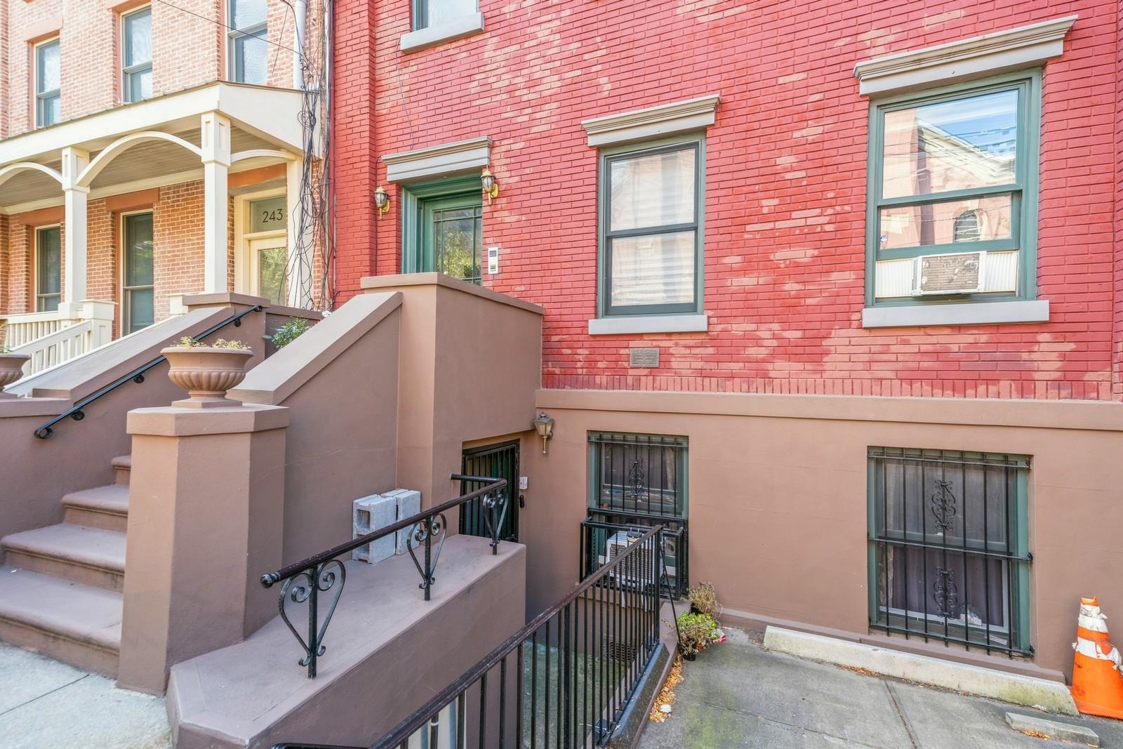 245 3rd Street, Unit 2 Jersey City, NJ 07302 - Photo 18 of 19 a front view of a house with many windows