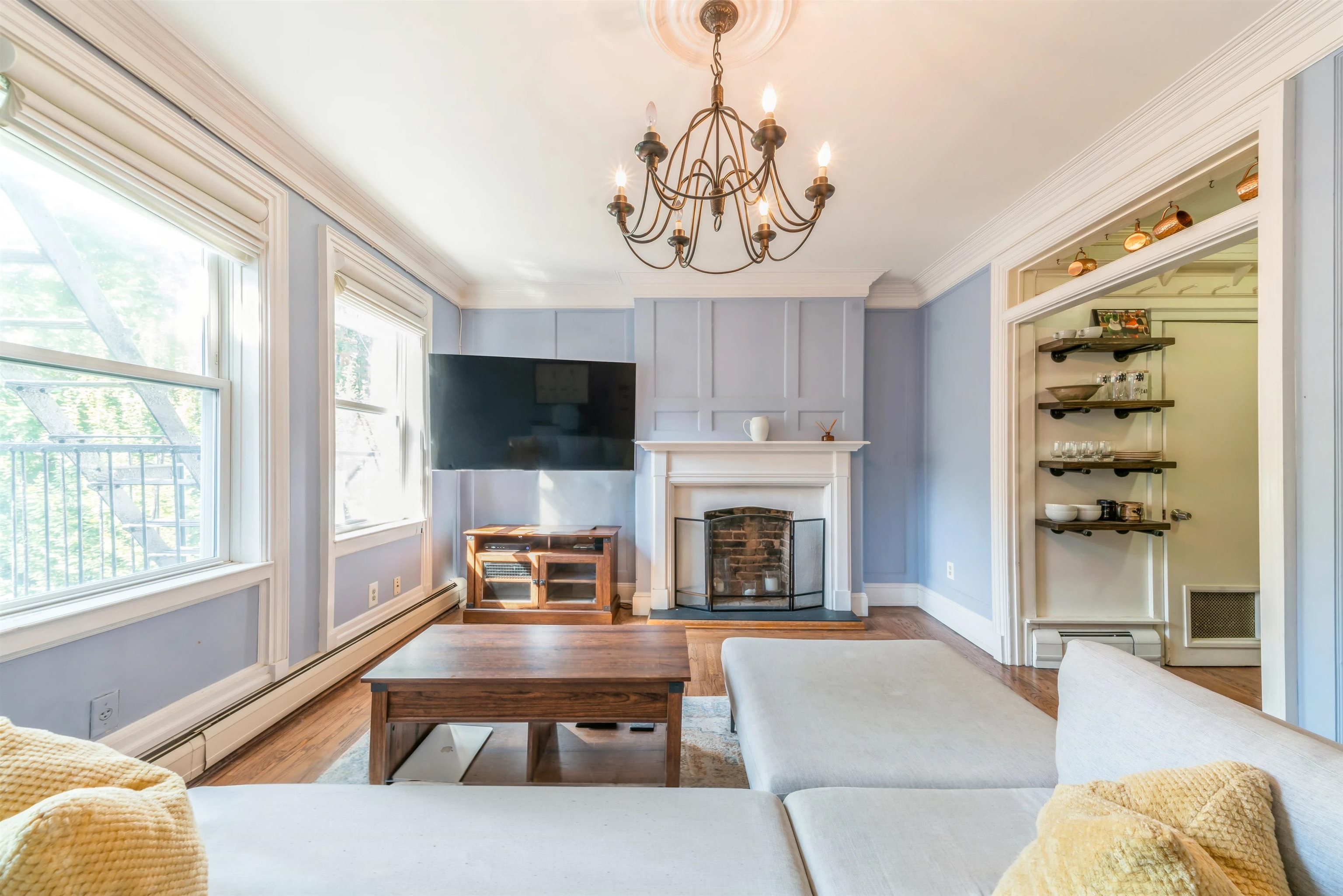 245 3rd Street, Unit 2 Jersey City, NJ 07302 - Photo 2 of 19 a living room with furniture a flat screen tv and a large window