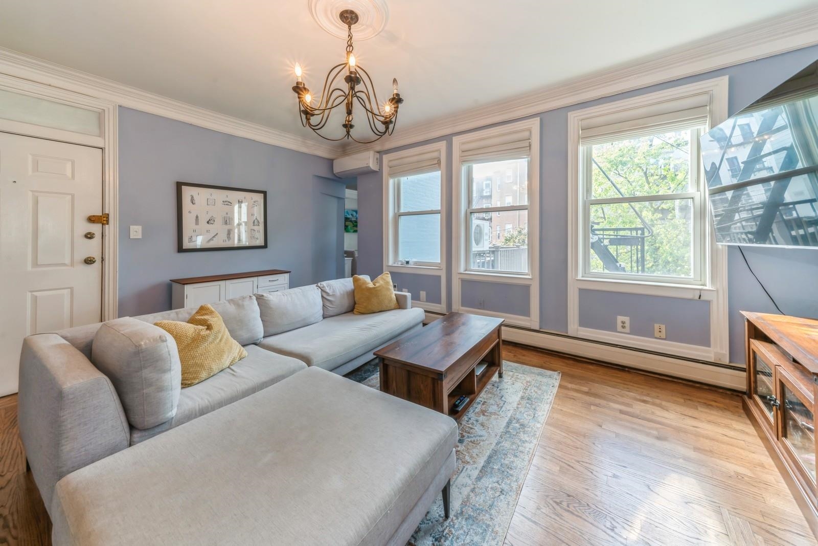 245 3rd Street, Unit 2 Jersey City, NJ 07302 - Photo 4 of 19 a living room with furniture and a large window