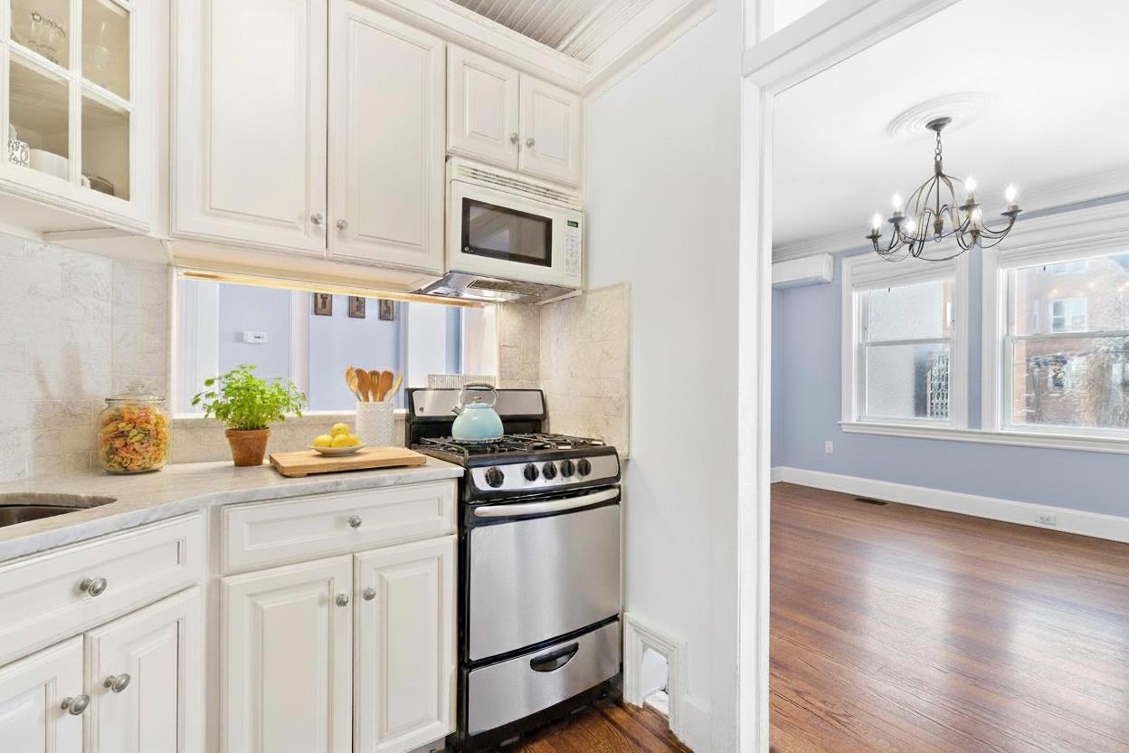 245 3rd Street, Unit 2 Jersey City, NJ 07302 - Photo 6 of 19 a kitchen with stainless steel appliances granite countertop a sink stove and cabinets