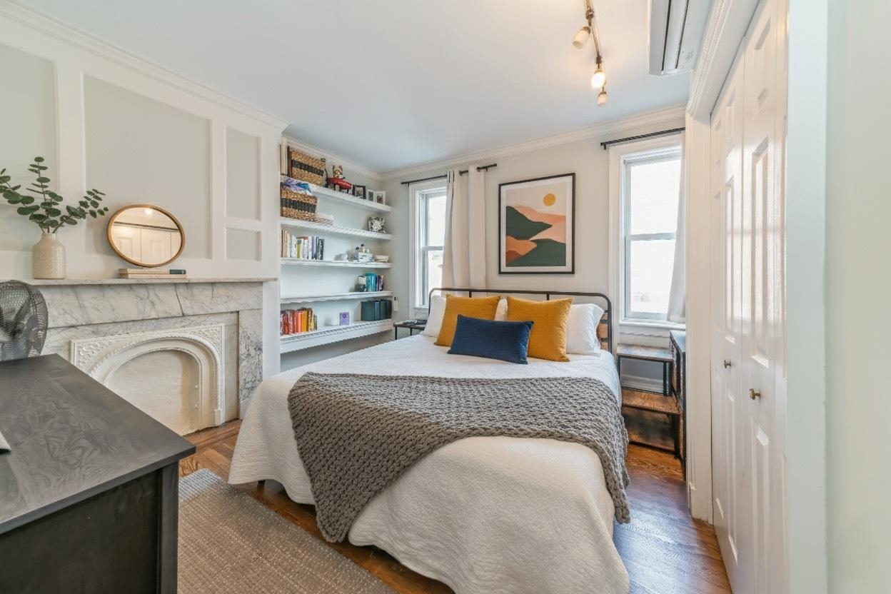 245 3rd Street, Unit 2 Jersey City, NJ 07302 - Photo 9 of 19 a bedroom with a bed and wooden floor