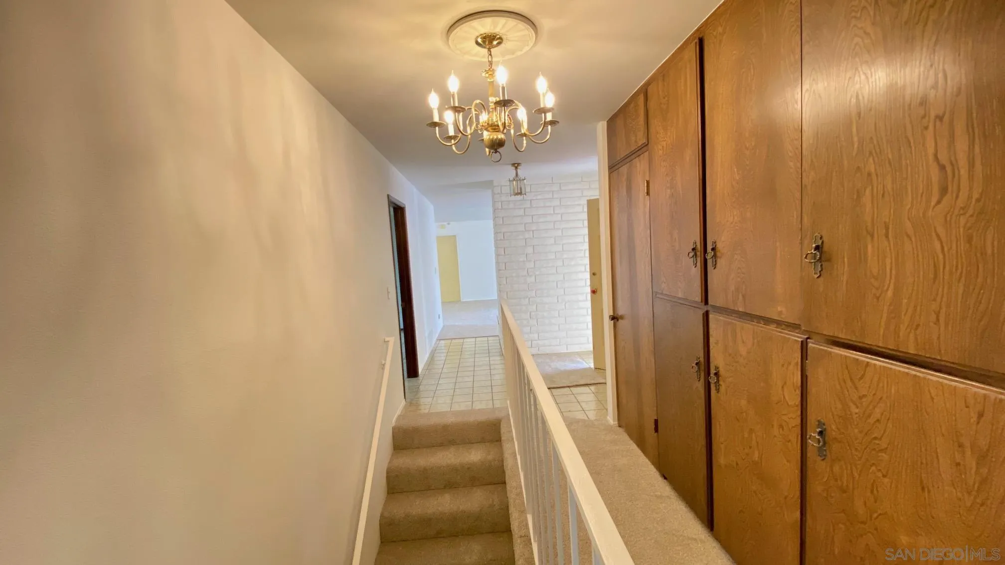 4351 Crestview Drive La Mesa, CA 91941 - Photo 20 of 49 a view of a chandelier in hallway with wooden floor