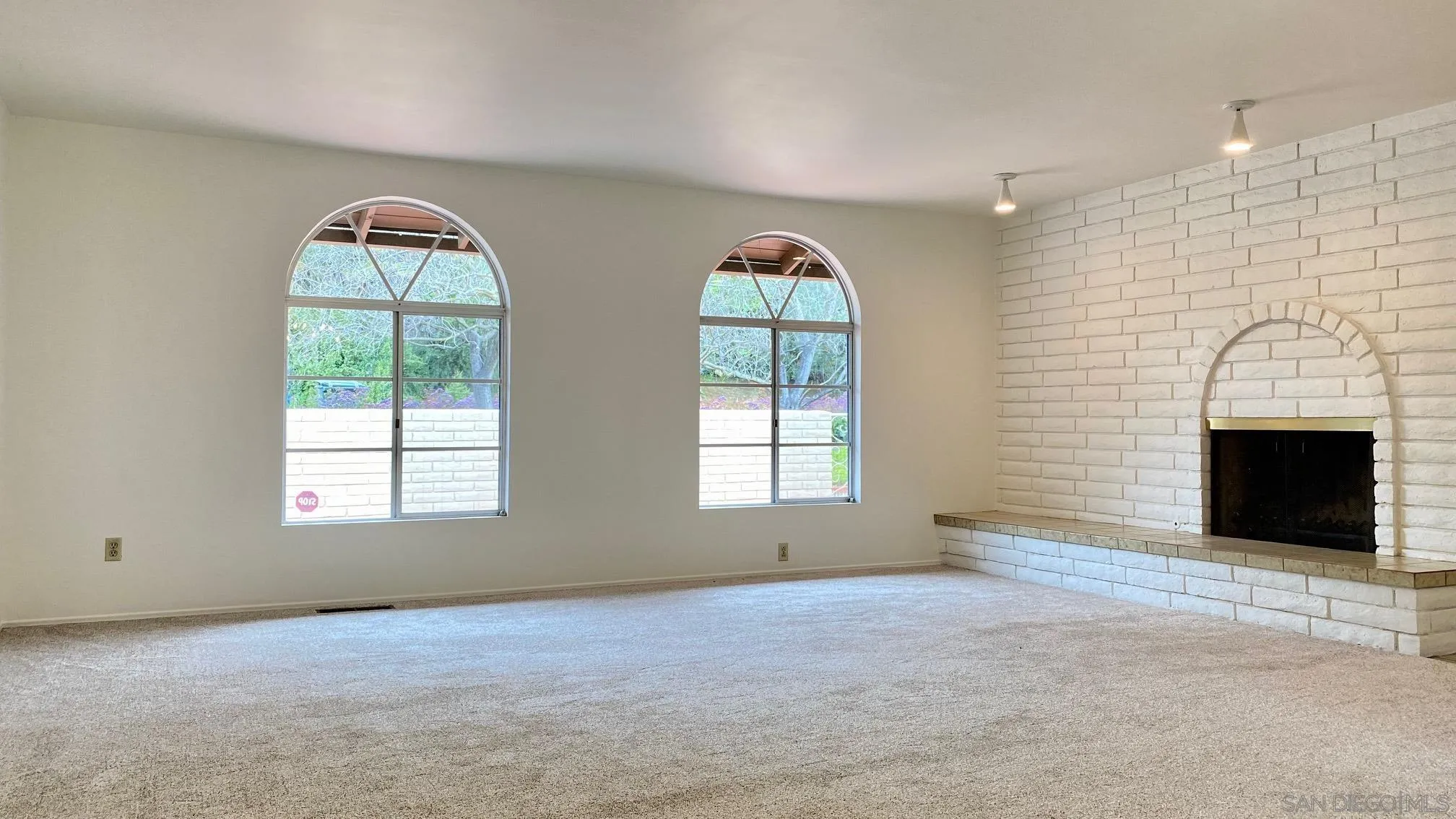 4351 Crestview Drive La Mesa, CA 91941 - Photo 21 of 49 an empty room with windows and fireplace