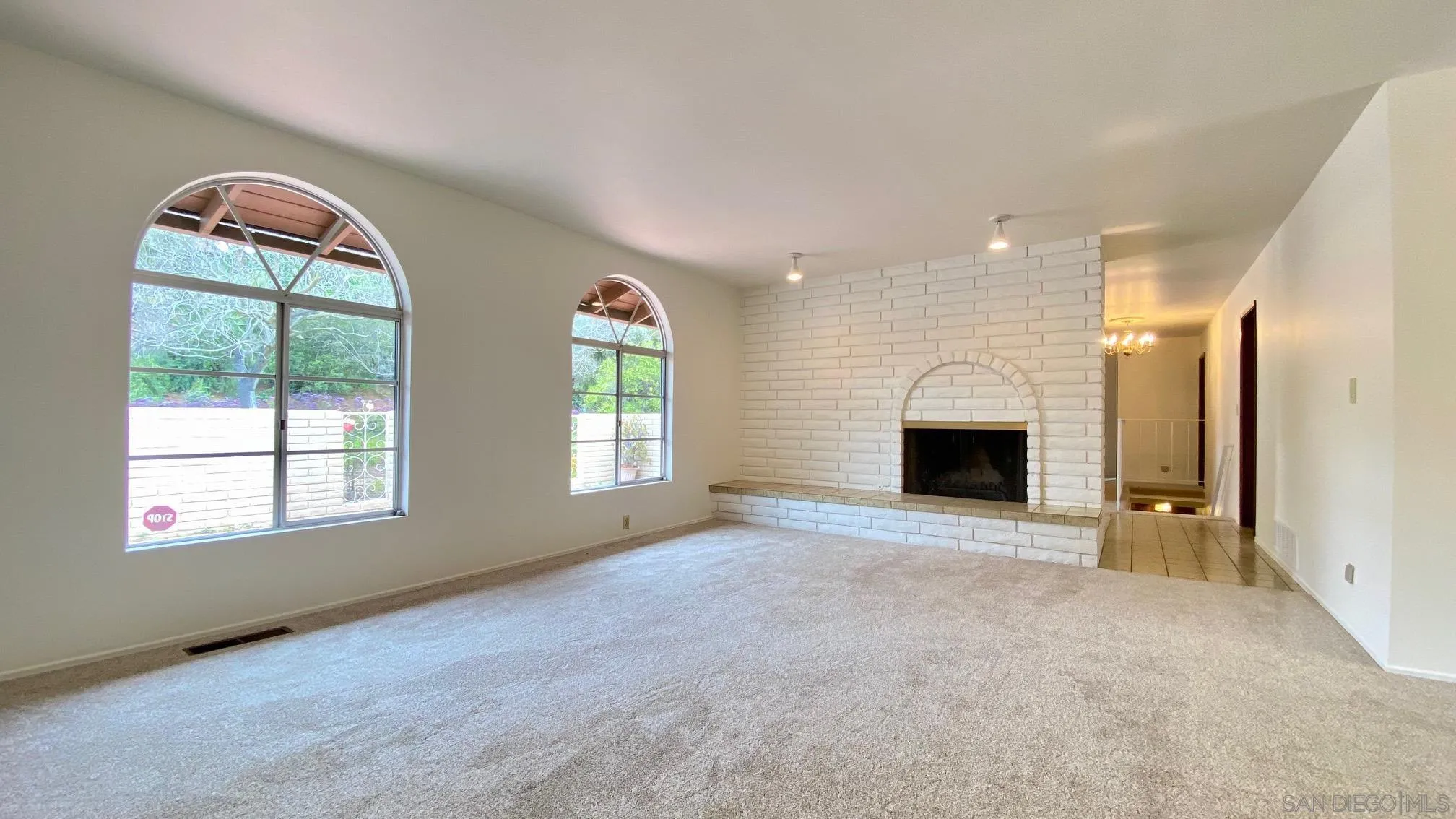 4351 Crestview Drive La Mesa, CA 91941 - Photo 22 of 49 an empty room with windows fireplace and bathroom