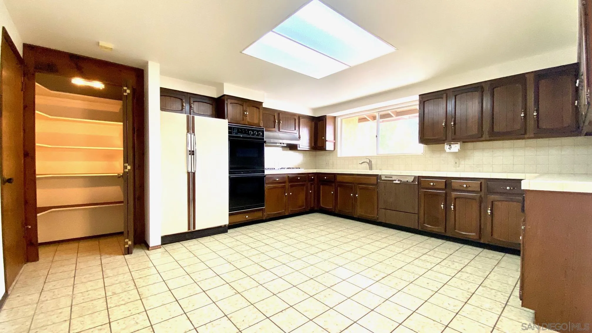 4351 Crestview Drive La Mesa, CA 91941 - Photo 24 of 49 a kitchen with stainless steel appliances a refrigerator and cabinets