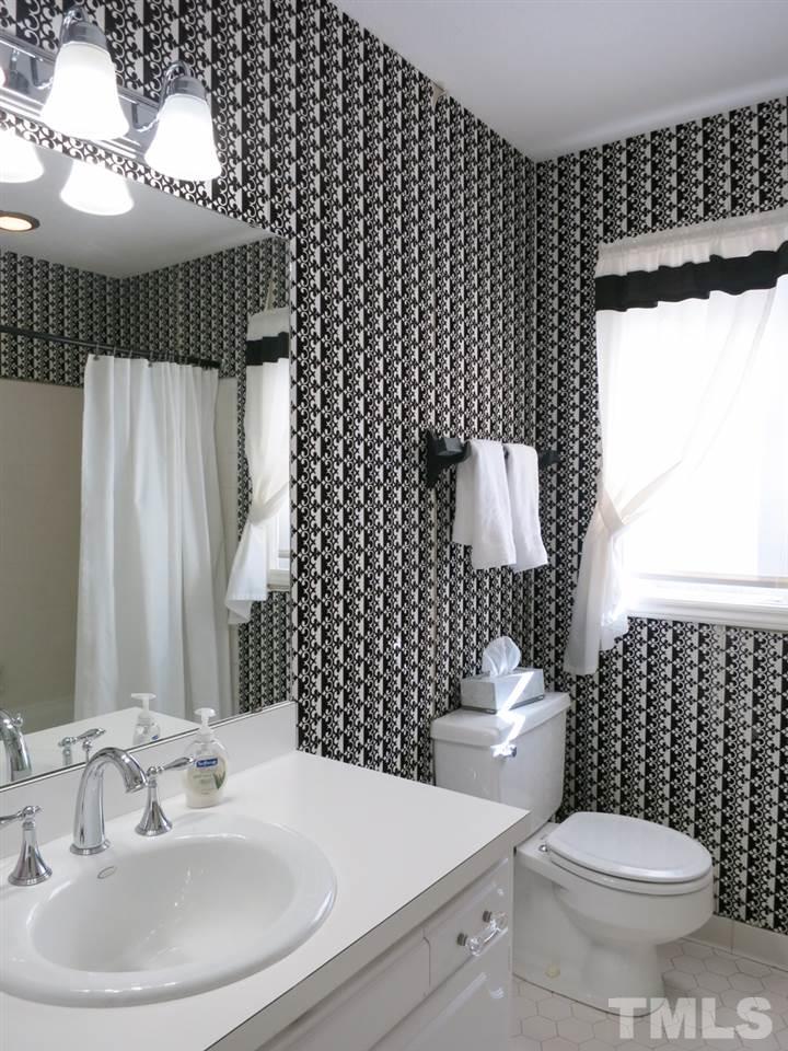 5809 Old Forge Circle Raleigh, NC 27609 - Photo 22 of 25 The tiled 2nd flr Hall Bath has a tiled floor, NEW light fixture, newer chrome faucets & tiled tub/shower; there is a deep storage closet in the hallway nearby.
