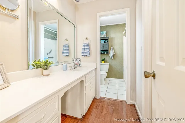 a spacious bathroom with a sink and a mirror
